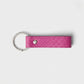 Llavero fucsia de Maison Caviar, accesorio decorativo y funcional, con diseño elegante y detalles llamativos.