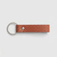Llavero Maison Caviar Capri de color naranja con diseño elegante y detalles en textura, ideal para llaves o accesorios.